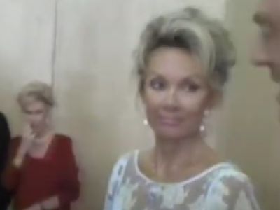 Kristina Tholstrup is wearing a white dress.